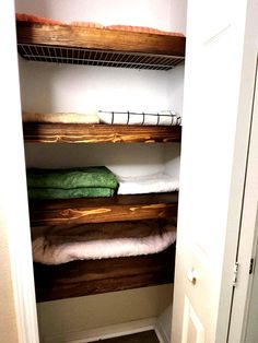 the closet is clean and ready to be used as a storage area for towels or other items