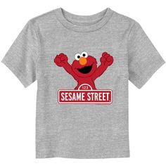 We can tell you how to get to Sesame Street and look good doing it, with these adorable designs for the whole family from the iconic, long-running children's series Sesame Street! Step onto Sesame Street with this officially licensed Toddlers' Classic Red Logo Sign Elmo Graphic T-Shirt featuring the adorable Elmo raising his arms in celebration and the classic Sesame Street sign in white and red style. Bring joy and laughter to your kids' day with this new Sesame Street apparel! Fun Red T-shirt For Playtime, Red Character Print T-shirt For Playtime, Red Graphic Print T-shirt For Playtime, Red Graphic Print Casual T-shirt, Sesame Street Sign, Sesame Street Signs, Street Apparel, Tv Clothes, Trending Graphic Tees