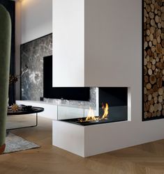 a modern fireplace with logs in the background