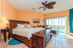 a bedroom with a large bed and ceiling fan