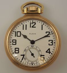 "This is a classic rail road grade pocket watch made by the Elgin Watch Co, USA The movement is a grade 478, model 15. Movement - the nickel ¾ plate movement has a lever escapement with a micrometer regulator. It has gold train wheels and capped escape wheel and lever. The movement is decorated with damascening and is signed \"BW Raymond, Elgin National Watch Co, USA, Adjusted 5 Positions, 21 Jewels\" # 25917937. The movement is in 90% mint condition - light scratches Case - the movement comes in a 10K gold plated open face case by Elgin, which has a screw off back and bezel. The case is signed \"BW Raymond Model\" and \"Cases and Timed by Elgin National Watch Co\". The case has milled edges. The rest of the case has a smooth plain finish and is in 95% mint condition - the case is in super Timeless Gold Pocket Watch Collectible, Timeless Collectible Pocket Watch With Polished Finish, Collectible Polished Pocket Watch, Plate Movement, Elgin Watch, Collectible Self-winding Yellow Gold Pocket Watch, Antique Yellow Gold Self-winding Pocket Watch, Blue Steel, G Shock