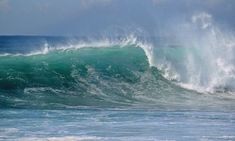 two surfers are riding large waves in the ocean