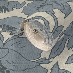 a roll of blue and white wallpaper with floral design on the bottom half of it