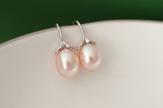 Pearl earrings Pearl size: 9-10mm Freshwater cultured pearl Pearl shape: oval High luster freshwater pearls Pearl color: light pink Pearl surface: clean Metal: 925 Sterling silver  Great for daily wear Remarks: Processing time for all orders is 1-3 business days. Pictures may vary due to viewing on different display devices. Clean Metal, Pink Pearl Earrings, How To Clean Metal, Pink Pearl, Pearl Color, Pearl Size, Hook Earrings, Fresh Water, Freshwater Pearls