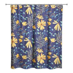 a blue shower curtain with yellow flowers and leaves on the outside, in front of a white background