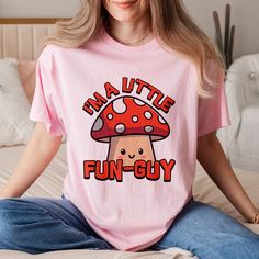 I'm A Little Fun Guy! This UNISEX cute mushroom pun t-shirt is a perfect blend of humor and style for those who love a good laugh with their fashion! Makes the perfect gift for lovers of fungi and puns! S, M, L, XL, 2XL, 3XL Checkout other cute and punny t-shirts: https://cuteandpunnydesigns.etsy.com Thank you for supporting our small business! Novelty Pink Crew Neck T-shirt, Kawaii T-shirt With Funny Print And Crew Neck, Kawaii Funny Print Crew Neck T-shirt, Pink Novelty T-shirt With Funny Print, Fun Pink Shirt With Funny Text, Funny Cartoon Print T-shirt, Pink Novelty Crew Neck T-shirt, Pink Crew Neck Novelty T-shirt, Pink Funny Print T-shirt