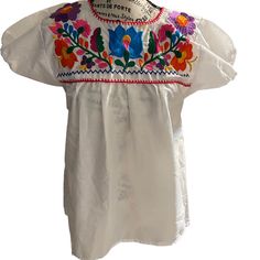 Beautiful Embroidered White Blouse, Handcrafted In Mexico Nice Colorful Embroidery 100% Cotton Womens White Blouse Size Small Measurements: Bust 20 Inches, 27 Inches Tall Embroidered White Blouse For Spring, Spring White Blouse With Embroidered Neckline, Fitted White Tops With Machine Embroidery, White Fitted Blouse With Floral Embroidery, Fitted White Blouse With Floral Embroidery, White Embroidered Top With Sleeves For Summer, Traditional White Shirt For Spring, White Embroidered Blouse For Spring, Traditional White Top With Floral Embroidery