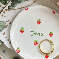 a white plate topped with a gold ring