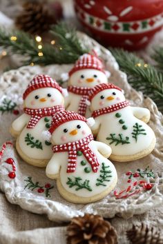 christmas cookies decorated like snowmen on a doily