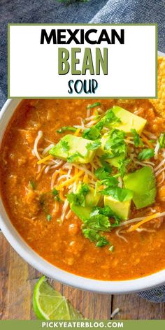 mexican bean soup in a white bowl with limes and cilantro on the side