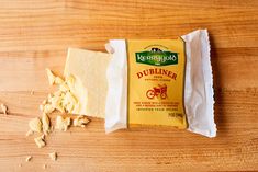 a bar of butter sitting on top of a wooden table next to a bag of butter