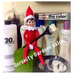 an elf is sitting on top of a counter with cosmetics and other items around him