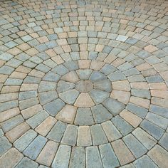 an image of a circular brick pattern on the ground with no people around it or in the background