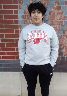 Head out in style with our Wisconsin Badgers Grey Defensive Leader Crew Sweatshirt! This Badgers Long Sleeve Sweatshirt features a screen print of mascot arched over team logo on center chest. You'll be warm, comfortable and stylish as you head to class, the game or just out on the town in this Wisconsin Crew Sweatshirt. Winter Crew Neck Sweats For Sports Events, Winter Fleece Sweats For Sports Events, Sports Fan Long Sleeve Fleece Sweatshirt, Fleece Sweatshirt With Logo For Fan Gear, Fleece Long Sleeve Sports Fan Sweatshirt, Fleece Sweatshirt For Sports Season Fan Apparel, Varsity Fleece Sweatshirt With Team Logo, Collegiate Winter Sweatshirt With Team Logo, Winter Team Logo Long Sleeve Sweatshirt