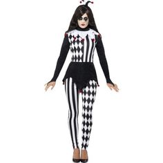 a woman dressed in a costume with black and white checkered tights, holding her hands out to the side