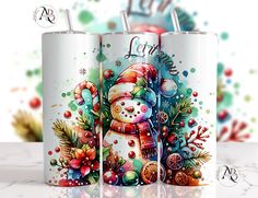 two christmas themed tumblers sitting next to each other