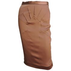 A beautiful copper brown stretch silk pencil skirt from Dolce & Gabbana. It has a waist band plus fabulous seaming and darts radiating from a center front panel. It is lined in same fabric, has a back kick pleat at the hem and a center back zipper. New with tags. Fits sizes Small, Medium. Marked Italian size 42. Waist 27" Hips 36-38" Length 24" Luxury Workwear Skirt With Gold Buttons, Luxury Formal Brown Skirt, Luxury Gathered Skirt For Workwear, Luxury Chic Silk Draped Skirt, Chic Luxury Silk Draped Skirt, Luxury Draped Skirt For Workwear In Spring, Luxury Silk Pencil Skirt, Luxury Fitted Silk Pencil Skirt, Luxury Silk Pencil Skirt For Party