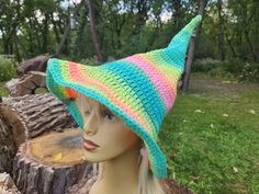 a mannequin head wearing a multicolored crocheted hat on it's head