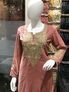 Style up with this elegant velvet kurta with Kashmiri Tilla embroidery. Pair this Tunic Top Kurta with a skirt, trousers, jeans, jeggings, dhoti or any other bottom and be ready in style.- - - - - - - - - - - - - - - - - - - - Product DetailsVelvet Kurta with Kashmiri Tilla Embroidery (Metallic Thread)- Condition: Brand New (Made to Order)- Fabric: Fine Velvet- Fully Lined from Inside- Features Pockets on both sides.- Colour: Peach- Length: 40" (102 cms approx, the mannequin is 6ft tall).- Care Traditional Tunic With Traditional Drape For Festive Season, Traditional Festive Tunic With Traditional Drape, Traditional Drape Festive Tunic, Zari Work Embroidered Top For Eid, Festive Velvet Kurta, Festive Embroidered Straight Kurta For Eid, Traditional Embroidered Top For Eid Designer Wear, Traditional Embroidered Top For Eid, Designer Velvet Traditional Wear With Long Sleeves