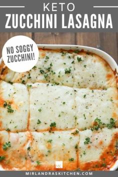 a casserole dish with cheese and parsley in it, on top of a wooden table