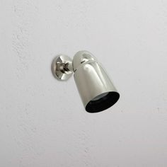 a light that is on the side of a wall in a room with white walls