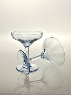 two wine glasses sitting next to each other on a table