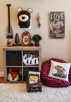 a living room with a teddy bear on the wall and other items in boxes around it