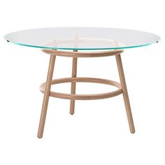 an oval glass table with wooden legs