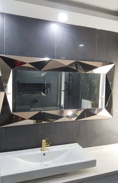 a bathroom sink sitting under a large mirror