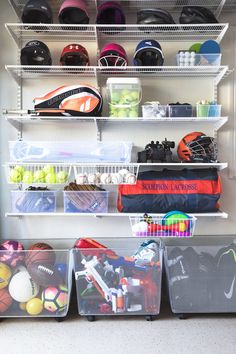 a closet filled with lots of sports gear and items in bins on top of shelves