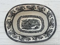 a black and white plate with an image of a city in the center on it