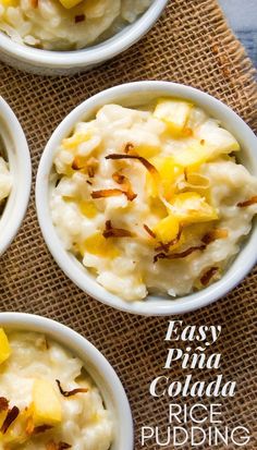 four white bowls filled with mashed potatoes on top of a burlied cloth