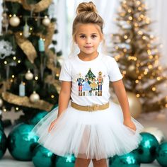 Celebrate Christmas in style with our adorable Nutcracker shirt. This fun shirt comes in a sweatshirt or t-shirt and is perfect for your little one's Christmas and winter festivities. Get your little one ready for the holiday with this eye-catching graphic tee! 🌟 Product Details: Design: Colorful ballerinas, presents, mouse knight, nutcracker, Christmas tree, and presents Style: Unisex short-sleeve t-shirt or crewneck sweatshirt Sizes available: 2T-5T & YS-Y2XL (Please refer to the size chart f Toddler Christmas Sweatshirt, Mouse Knight, Christmas Tree And Presents, Nutcracker Shirt, Nutcracker Christmas Tree, Holiday Graphic Tees, Toddler Size Chart, Christmas Tee Shirts, Christmas Concert