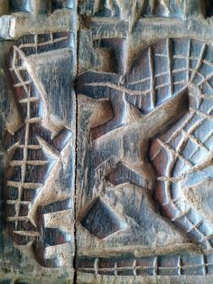 two carved wooden panels with different designs on them