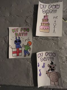 three children's drawings on paper taped to the wall