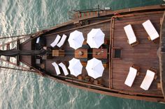 an overhead view of a boat with tables and umbrellas