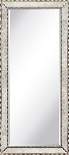 an ornate silver framed mirror on a white wall with beading around the edges and sides