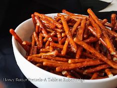 a white bowl filled with carrots on top of a table