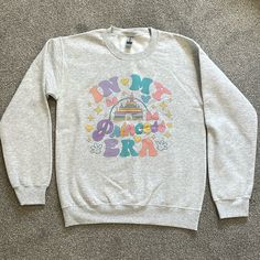 Adorable Women’s Princess Themed Sweatshirt - Perfect For Your Upcoming Disney Trip! Purchased Off Of An Etsy Shop And Unfortunately I Selected The Wrong Size, So This Has Never Been Worn. Grey Disneyland Sweatshirt, Princess Sweatshirt, Disney Princess Hoodie, Disney Princess Sweatshirt, Disney Long Sleeve T-shirt For Disney Trips, Red Scrubs, Lululemon Shirt, Under Armour Hoodie, Mesh Bodysuit