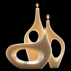 two candles are lit in the shape of shapes