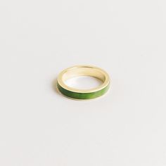 a green ring sitting on top of a white surface