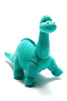 a knitted toy dinosaur on a white background