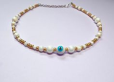 This beautiful necklace is handmade with round pearl beads, gold seed beads, and a beautiful turquoise and white evil eye. It is approximately 14 inches long and comes with additional extender chain, making it easily adjustable. The pearls reflect the light beautifully, making this a great summer necklace. Reach out with any questions! White Bohemian Necklace With Evil Eye, Bohemian White Necklace With Evil Eye Detail, White Bohemian Beaded Necklace With Evil Eye, Bohemian White Beaded Necklace With Evil Eye, Bohemian White Evil Eye Necklace, Adjustable White Beaded Necklace With Evil Eye, White Evil Eye Jewelry For Festivals, White Evil Eye, Pearl Necklace Gold