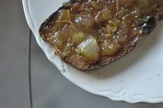 there is a piece of bread on a plate with some type of food on it