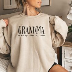 Shop our entire Mother's Day Collection Here: https://www.etsy.com/ca/shop/WeLoveCustomStudio?section_id=48331949 Looking for a heartfelt Mother's Day gift? Our cozy sweater is not just a piece of clothing; it's a personalized keepsake that Grandma or Nana will cherish forever. With our custom Grandma Shirt and Nana Shirt options, you can add their grandkids' names for a truly special touch. Each Custom Grandma Shirt and Custom Nana Shirt is carefully crafted with love and attention to detail, e Grandma Sweatshirt, Idee Cricut, Grandma Sweater, Cute Shirt Designs, Personalized Grandma, Grandma Shirts, Grandma Gift, Mom And Grandma, Custom Sweatshirts