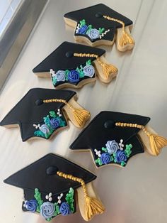 decorated cookies in the shape of graduation caps