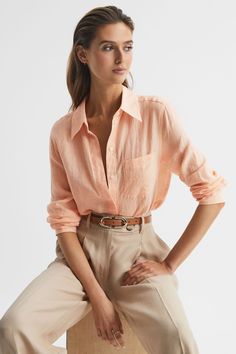 Crafted in a lightweight linen for a cool and comfortable wear is the peach Campbell shirt. This piece has long sleeves with a full-button close and a traditional point collar. Wear with relaxed trousers and sandal heels for an edit with refined appeal. Point collar Buttoned front closure Patch pocket to chest Long sleeves 100% linen Curved hemline The model is wearing a size 8 Measurements of model: Height 5ft 10 / 178cm Orange Shirts Women, Linen Shirt Style Women, Coral Color Outfits, Peach Color Clothes, Peach Colour Outfit, Peach Shirt Outfit For Women, Orange Linen Shirt Outfit, Peach Outfits For Women, Peach Trousers Outfits