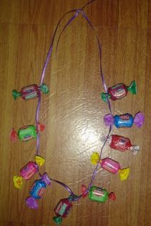 a necklace made out of candy on top of a wooden table