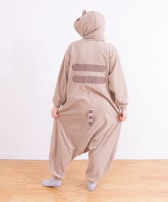 Click to see size chart The Pusheen Classic Unisex Kigurumi is the perfect way to lounge while still looking cute! This full-body traditional kigurumi onesie is made of super soft fleece and highlights all of Pusheen's best characteristics including tail and whiskers! Unisex loose fit. Hood with Pusheen ears and embroidered face. Back features Pusheen stripes and stuffed tail. Zippered front. Roomy side pockets. Fit: Model is wearing size Small/Medium. Small/Medium typically fits standard XS-2XL Pusheen Onesie, Giant Pusheen Plushie, Pusheen Cat Plush, Adult Onesie Pajamas Cat, Pusheen Plush Keychain, Cat Onesie, Pusheen Shop, Pusheen Plush, Halloween Door Wreaths