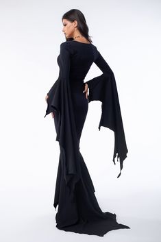 Step into your Gothic fantasy with this bewitching maxi dress. Featuring exaggerated bat-wing sleeves and a dramatic bat-shaped train, this dress flows like shadows in the night. The striking silhouette makes it the perfect fit for spectacular photos, perfect for those who dare make an unforgettable entrance this Halloween. FEATURES: > Plunging Neckline  > Long Exaggerated Bat-Like Sleeves  > Mermaid Cut with Bat-Like Train  > Luxurious Black Lycra Bat Wing Dress, Bat Dress, Wing Dress, Night Shadow, Wing Sleeves, Batwing Dress, Bat Wing, Gothic Dress, Art Clothes